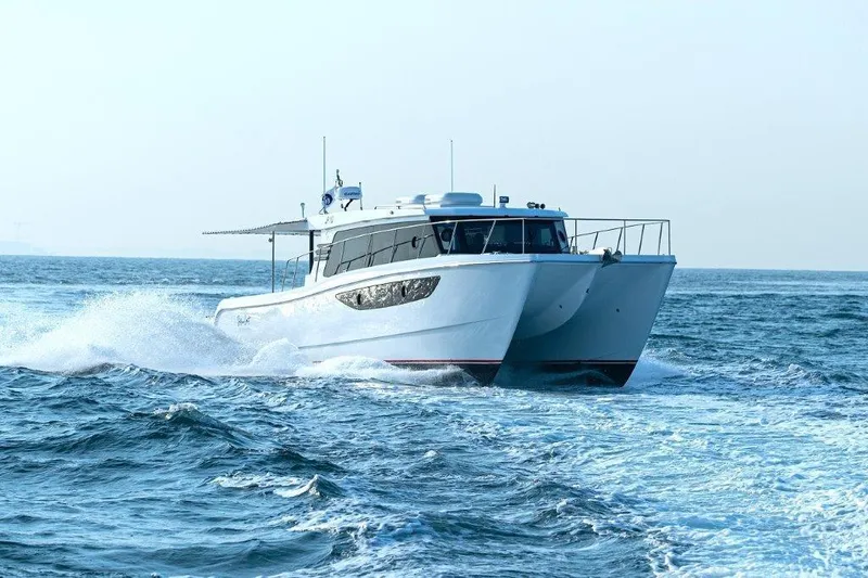  Yacht Photos Pics SilverCAT 46LUX 2026 catamaran cruising on open sea, creating waves.