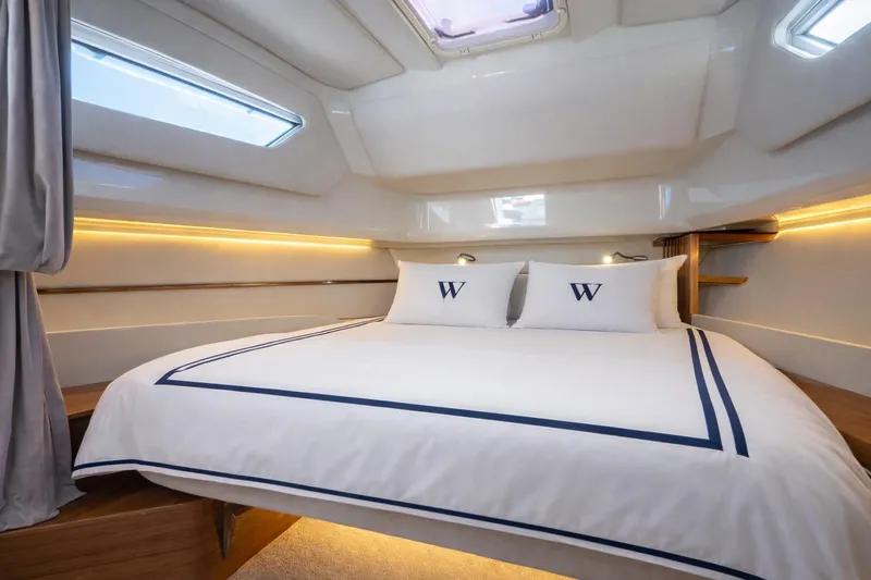  Yacht Photos Pics Luxurious cabin interior of 2026 Wiszniewski Yachts W43 with elegant bedding and ambient lighting.