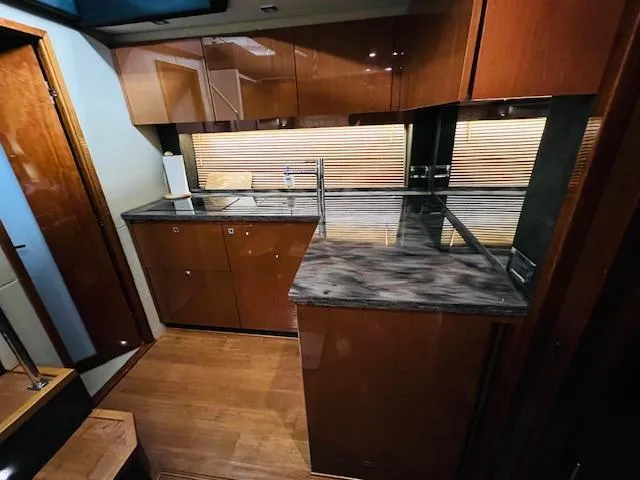  Yacht Photos Pics Luxurious kitchen interior of 2016 Sea Ray 470 Sundancer yacht with modern cabinetry and countertops.