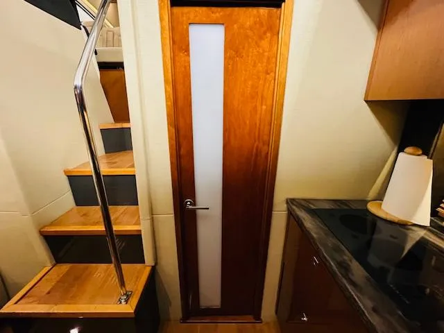  Yacht Photos Pics Interior of 2016 Sea Ray 470 Sundancer with wooden door and staircase.