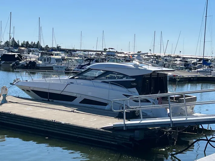  Yacht Photos Pics 2016 Sea Ray 470 Sundancer yacht docked at a marina under clear blue skies.