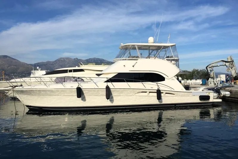 Pope Yacht Photos Pics 2003 Riviera Marine Riviera 51 yacht docked at marina, clear sky background.