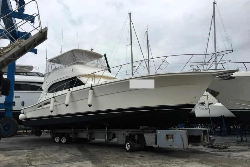 Pope Yacht Photos Pics 2003 Riviera Marine Riviera 51 yacht on trailer at marina, surrounded by other boats.