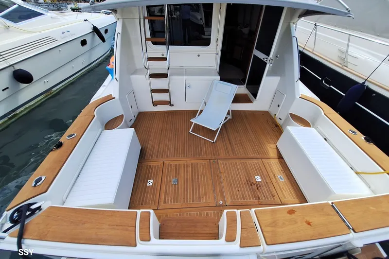 Pope Yacht Photos Pics 2003 Riviera Marine Riviera 51 yacht deck with seating and ladder.