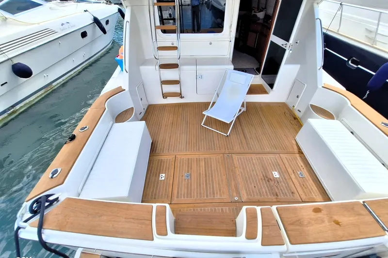 Pope Yacht Photos Pics 2003 Riviera Marine Riviera 51 yacht deck with wooden flooring and seating area.