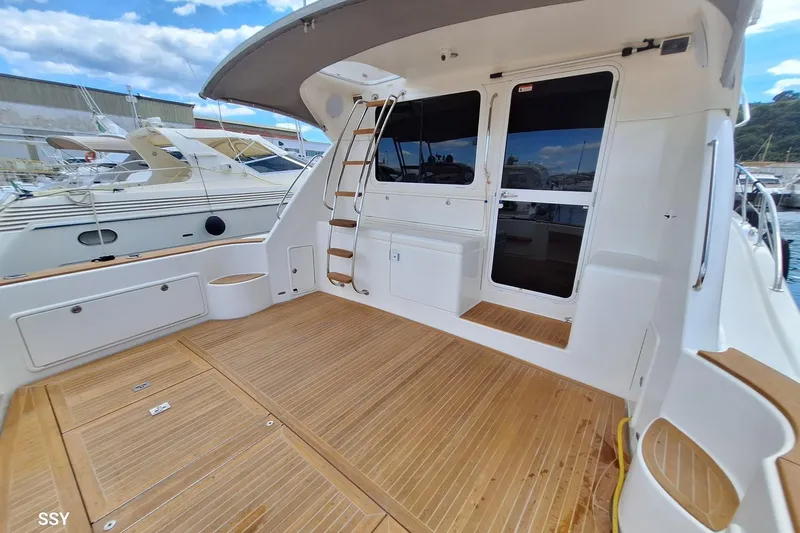 Pope Yacht Photos Pics 2003 Riviera Marine Riviera 51 yacht deck with wooden flooring and ladder.