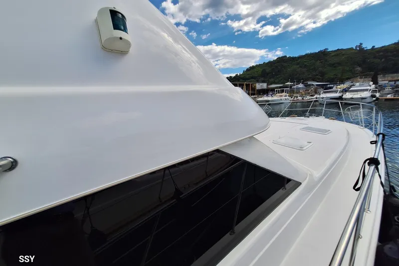 Pope Yacht Photos Pics 2003 Riviera Marine Riviera 51 yacht docked at marina under blue sky.