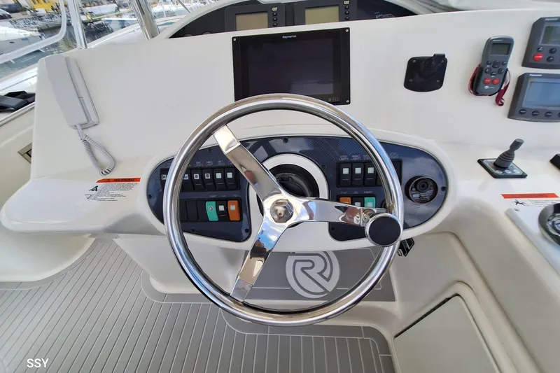 Pope Yacht Photos Pics Steering wheel and controls of a 2003 Riviera Marine Riviera 51 yacht.