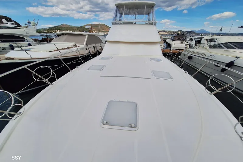 Pope Yacht Photos Pics 2003 Riviera Marine Riviera 51 yacht docked at marina, surrounded by other boats.