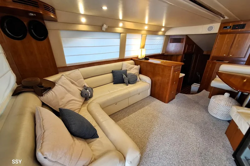 Pope Yacht Photos Pics Luxurious interior of 2003 Riviera Marine Riviera 51 yacht with plush seating and elegant wood finishes.