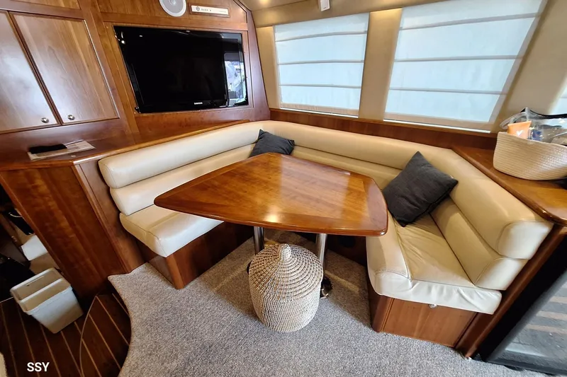 Pope Yacht Photos Pics Luxurious 2003 Riviera Marine Riviera 51 yacht interior with elegant seating and wooden table.