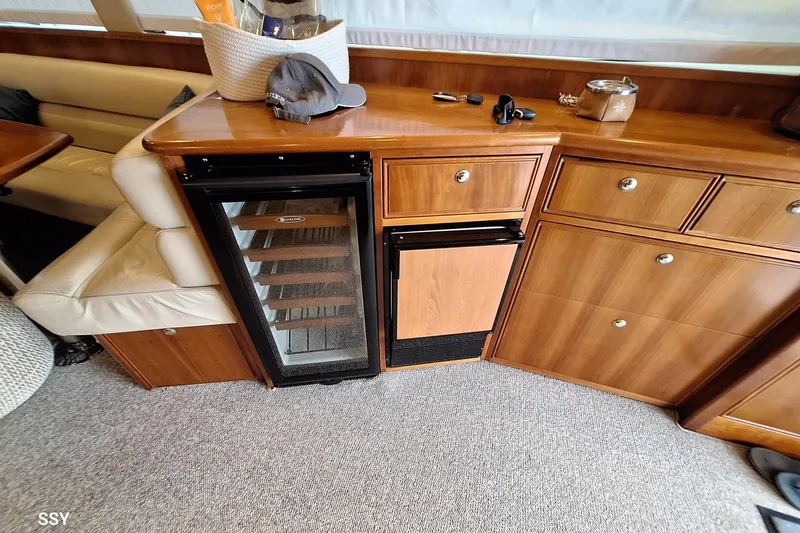 Pope Yacht Photos Pics Interior of 2003 Riviera Marine Riviera 51 yacht with wooden cabinetry and mini fridge.