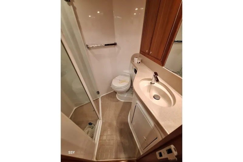 Pope Yacht Photos Pics Bathroom interior of 2003 Riviera Marine Riviera 51 yacht, featuring sink and toilet.