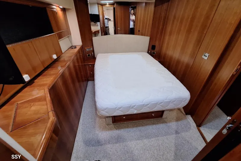Pope Yacht Photos Pics Luxurious bedroom interior of 2003 Riviera Marine Riviera 51 yacht with wooden furnishings.