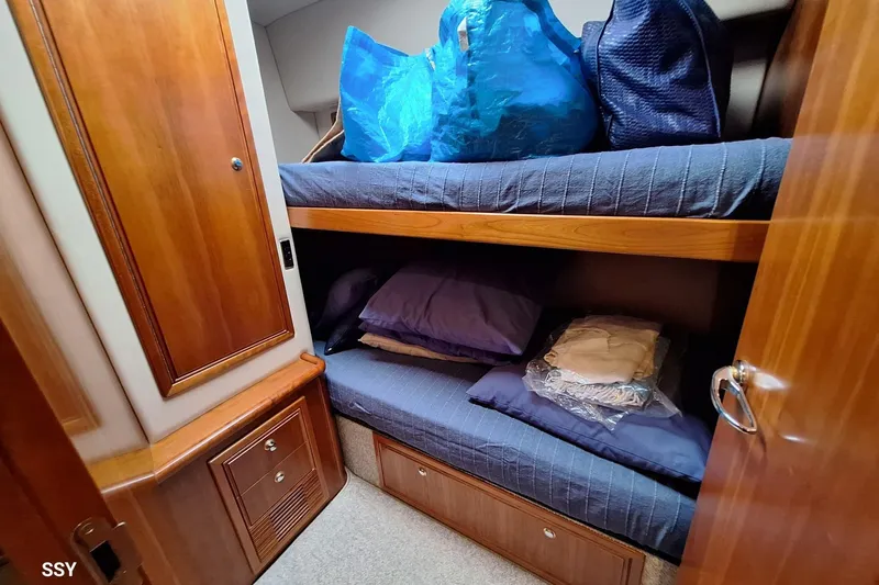 Pope Yacht Photos Pics 2003 Riviera Marine Riviera 51 yacht cabin with wooden interior and bunk beds.