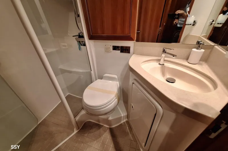 Pope Yacht Photos Pics 2003 Riviera 51 yacht bathroom with shower, toilet, and sink.