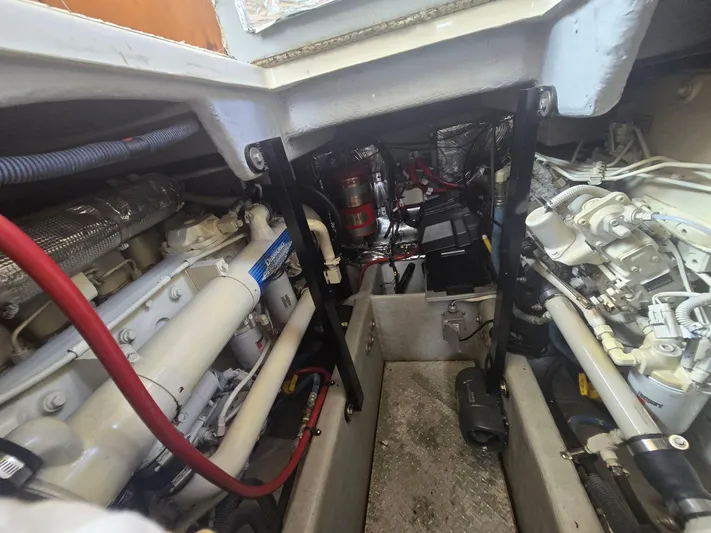 Why Not Yacht Photos Pics Engine room of a 2005 Meridian 381 Sedan boat, showcasing mechanical components and wiring.