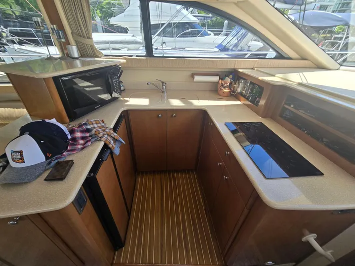 Why Not Yacht Photos Pics 2005 Meridian 381 Sedan yacht kitchen with microwave, sink, and stovetop.