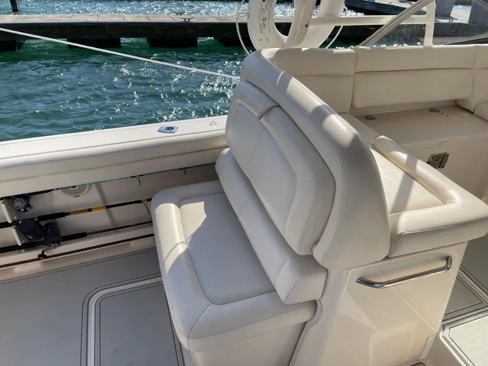  Yacht Photos Pics 2016 Grady-White Freedom 335 boat interior with white seating by the water.