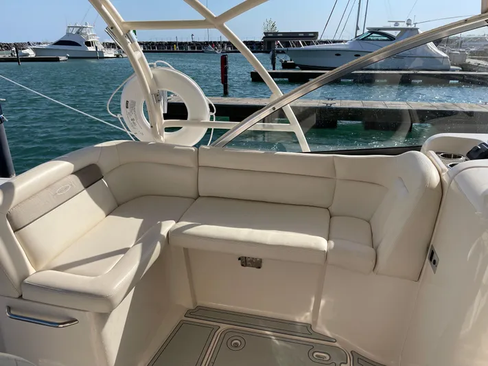  Yacht Photos Pics 2016 Grady-White Freedom 335 boat interior with beige seating, docked at marina.