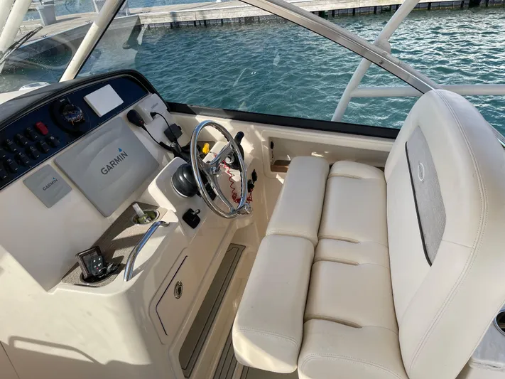  Yacht Photos Pics 2016 Grady-White Freedom 335 helm with Garmin system, white seating, and ocean backdrop.