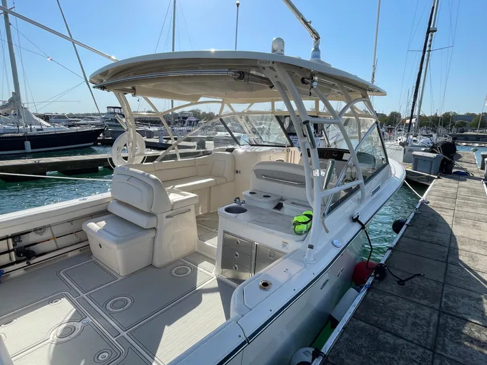  Yacht Photos Pics 2016 Grady-White Freedom 335 boat docked, featuring spacious seating and modern design.