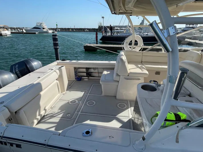  Yacht Photos Pics 2016 Grady-White Freedom 335 boat interior at marina, featuring spacious seating and twin engines.