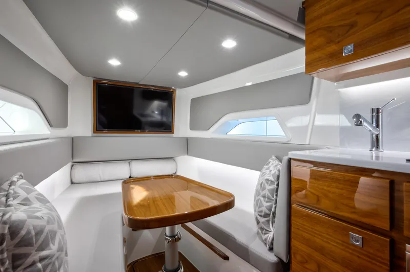 Code Blu Yacht Photos Pics 2022 Valhalla Boatworks 46 Center Console interior with modern seating, table, and TV.