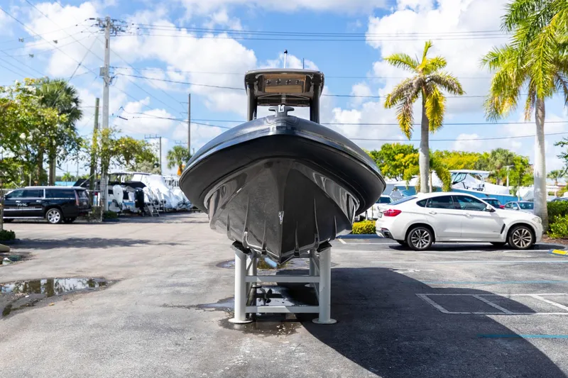 Airship 310 Yacht Photos Pics 2023 Airship 310 boat displayed in a sunny parking lot with palm trees.