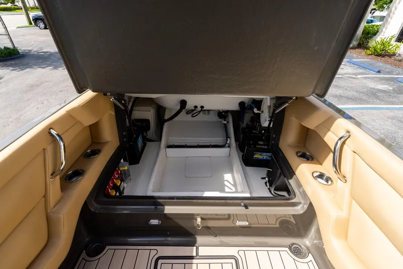 Airship 310 Yacht Photos Pics Open storage compartment in 2023 Airship 310 boat, featuring beige interior and cup holders.