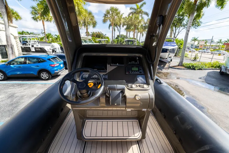 Airship 310 Yacht Photos Pics Cockpit of 2023 Airship 310 boat with steering wheel and control panel.