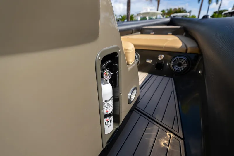 Airship 310 Yacht Photos Pics 2023 Airship 310 boat interior with fire extinguisher compartment and seating area.