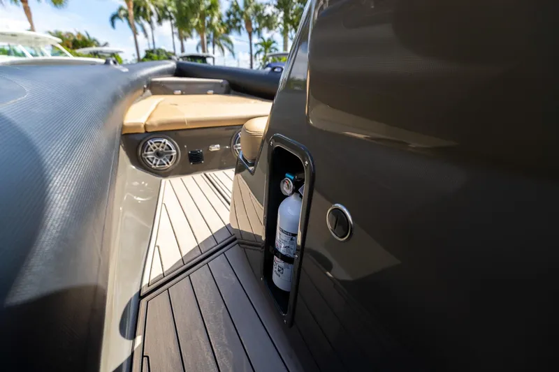 Airship 310 Yacht Photos Pics Interior of 2023 Airship 310 boat with fire extinguisher and seating area.