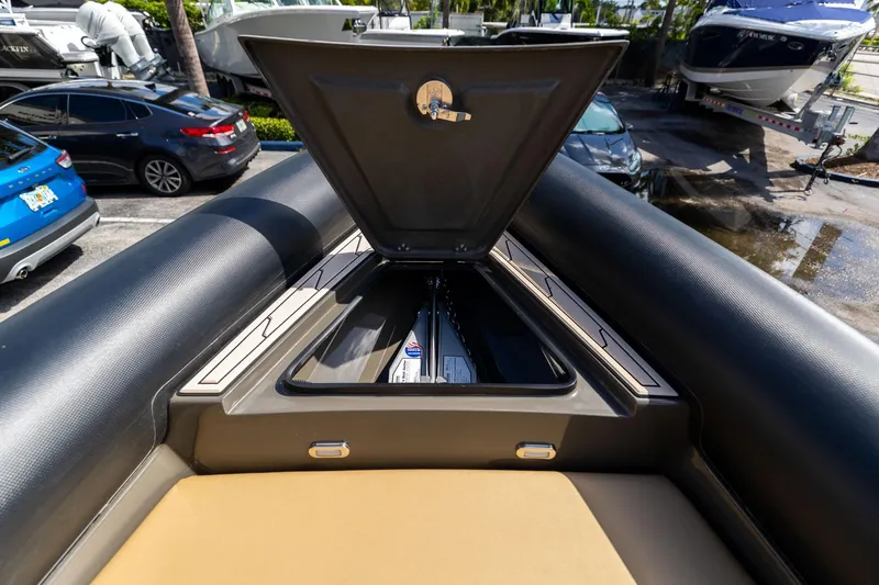 Airship 310 Yacht Photos Pics Open storage compartment on 2023 Airship 310 boat, parked near vehicles and other boats.