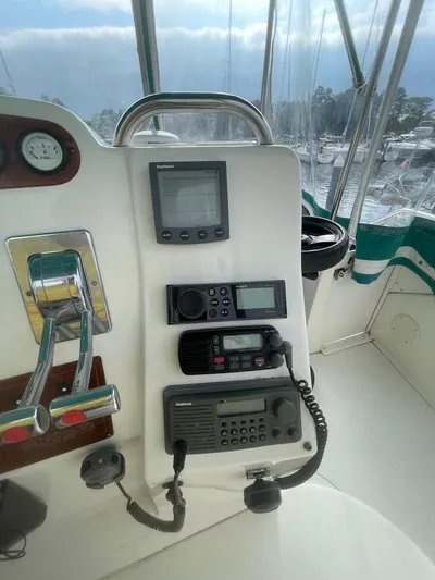 Scott Free & Gigi Too Yacht Photos Pics 2002 Silverton 392 Motor Yacht helm with navigation and communication equipment.