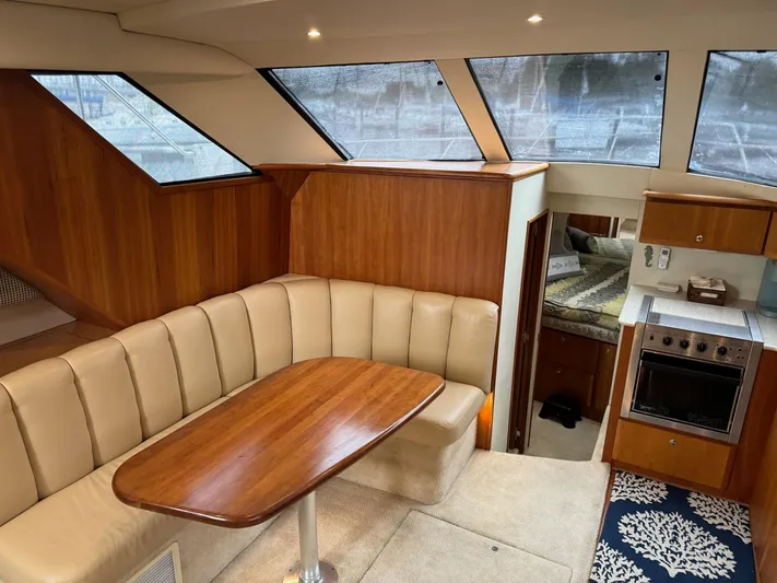 Scott Free & Gigi Too Yacht Photos Pics Interior of 2002 Silverton 392 Motor Yacht with dining area and kitchen.