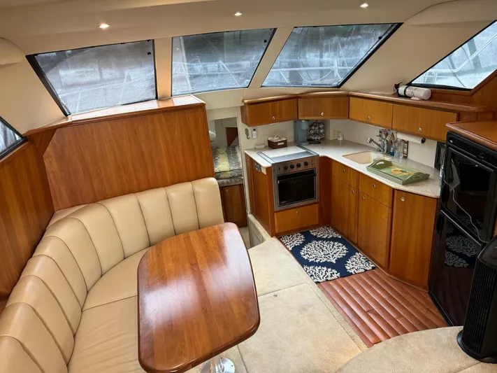 Scott Free & Gigi Too Yacht Photos Pics Interior of 2002 Silverton 392 Motor Yacht with kitchen and seating area.