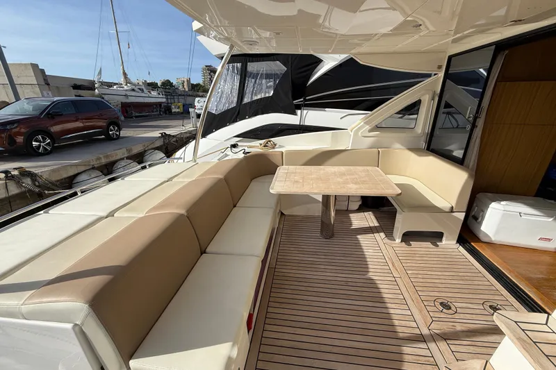  Yacht Photos Pics Luxurious seating area on 2015 Absolute 56 FLY yacht with elegant wood flooring.