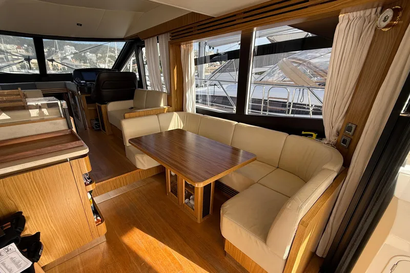  Yacht Photos Pics Luxurious interior of a 2015 Absolute 56 FLY yacht with elegant wood and leather seating.