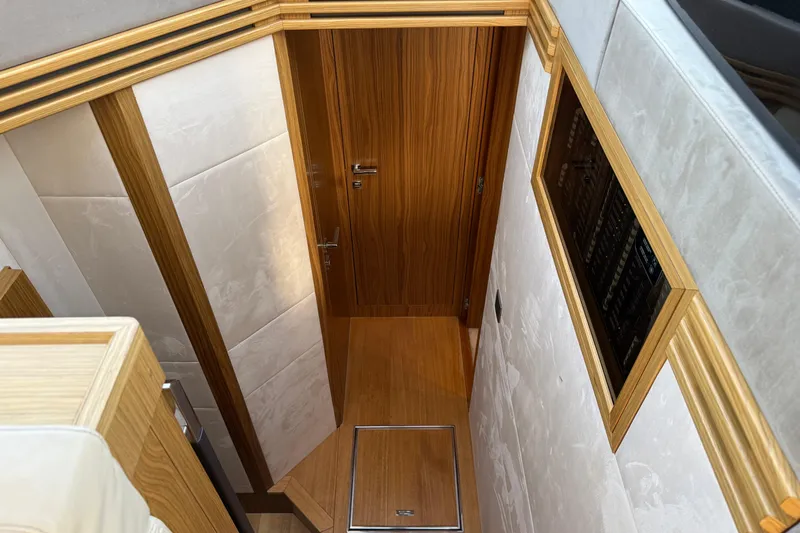  Yacht Photos Pics Interior hallway of 2015 Absolute 56 FLY yacht with wooden door and paneling.
