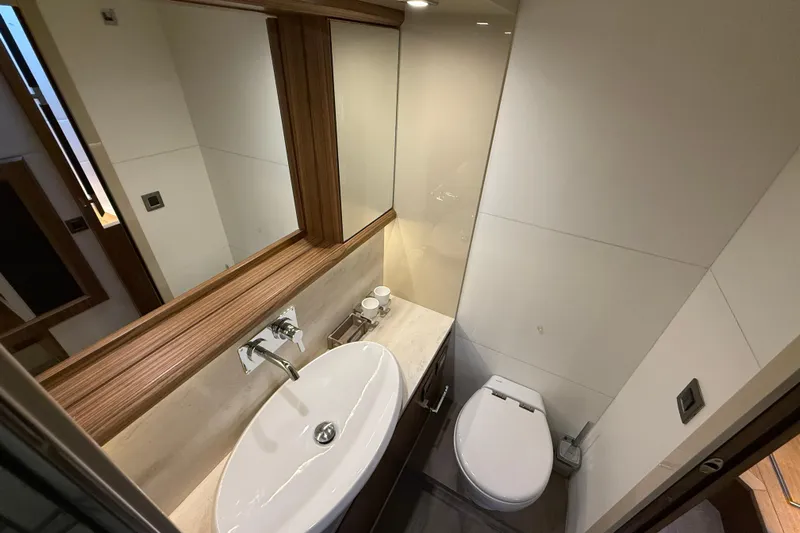  Yacht Photos Pics Luxurious bathroom in 2015 Absolute 56 FLY yacht with modern sink and toilet.
