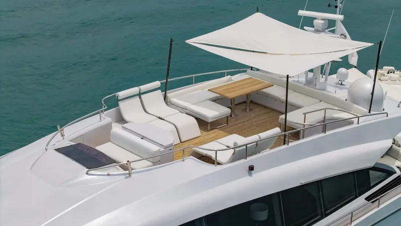 Le Caprice IV Yacht Photos Pics Luxurious 2011 Pershing 108 yacht deck with seating and canopy on turquoise water.