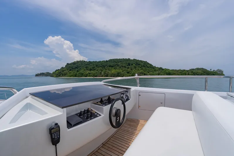 Le Caprice IV Yacht Photos Pics Helm of 2011 Pershing 108 yacht with island view and clear skies.