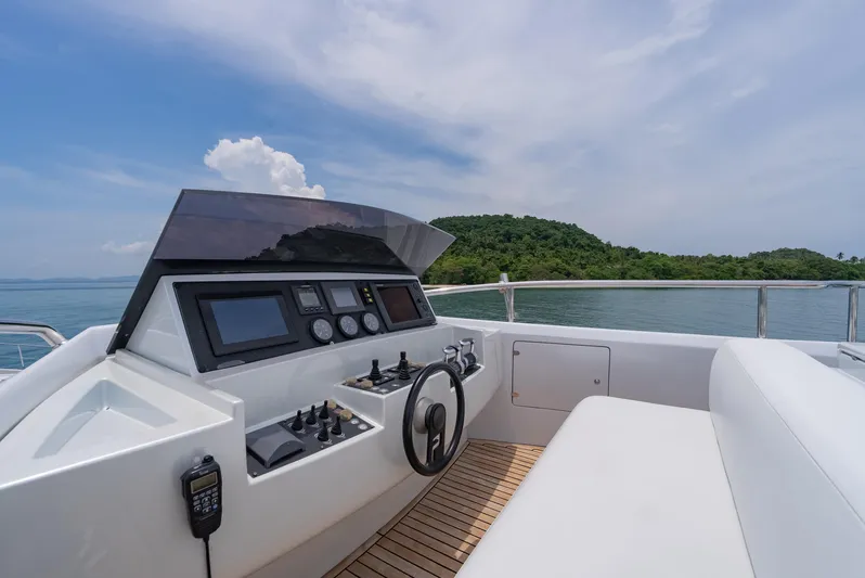 Le Caprice IV Yacht Photos Pics Cockpit of 2011 Pershing 108 yacht with scenic ocean and island view.