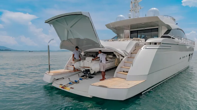 Le Caprice IV Yacht Photos Pics Luxury Pershing 108 yacht from 2011 with open garage and crew on deck.