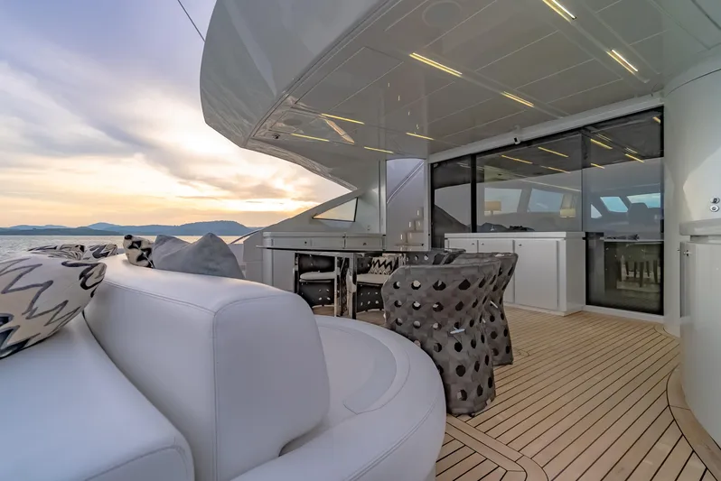 Le Caprice IV Yacht Photos Pics Luxurious 2011 Pershing 108 yacht deck with elegant seating and ocean view at sunset.