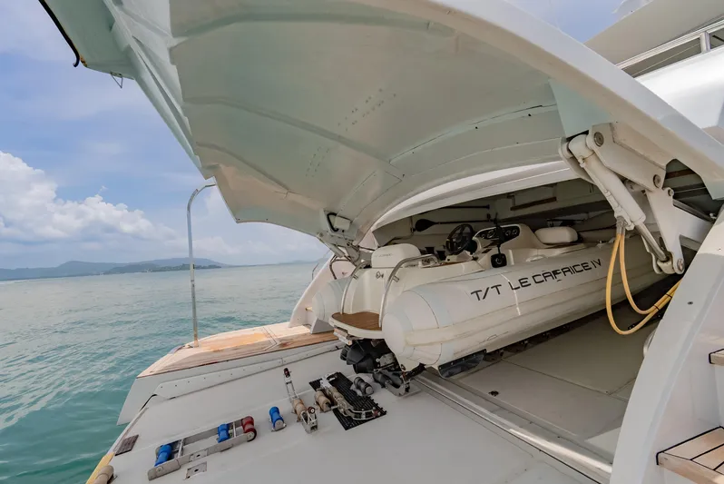 Le Caprice IV Yacht Photos Pics Pershing 108 yacht with tender garage open, revealing stored boat, 2011 model.