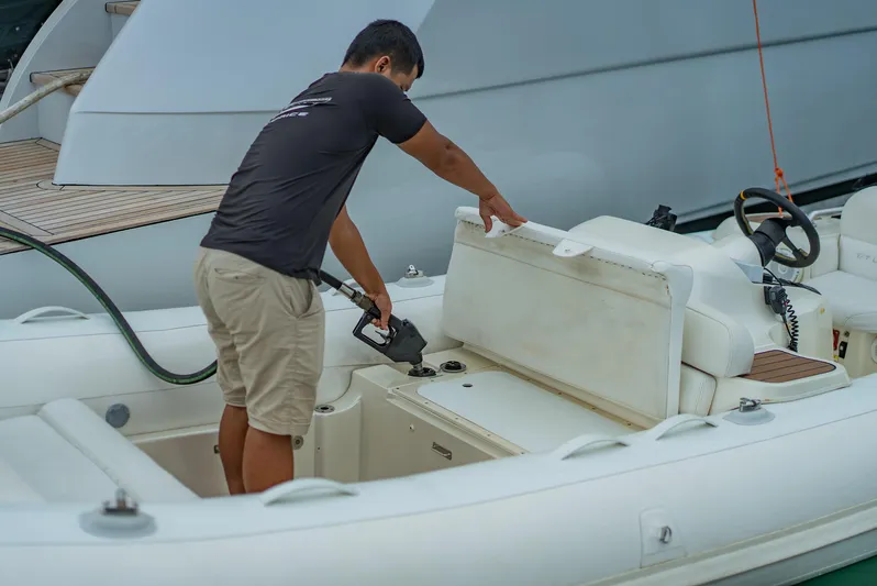 Le Caprice IV Yacht Photos Pics Man refueling a boat near a Pershing 108 yacht, 2011 model.