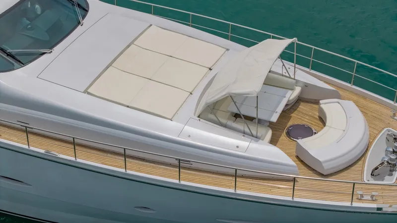 Le Caprice IV Yacht Photos Pics Luxurious 2011 Pershing 108 yacht deck with seating and sunshade on turquoise water.