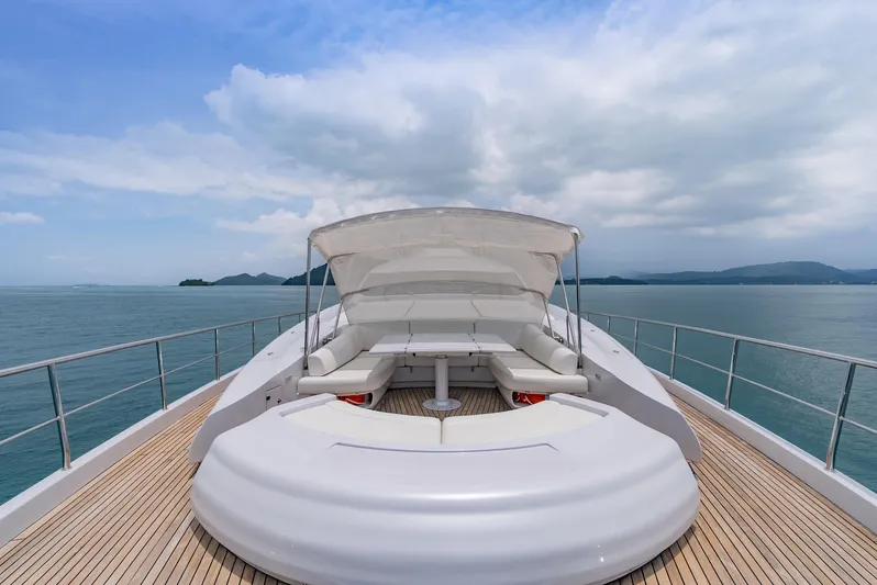 Le Caprice IV Yacht Photos Pics Luxurious 2011 Pershing 108 yacht deck with seating, overlooking serene ocean and distant islands.